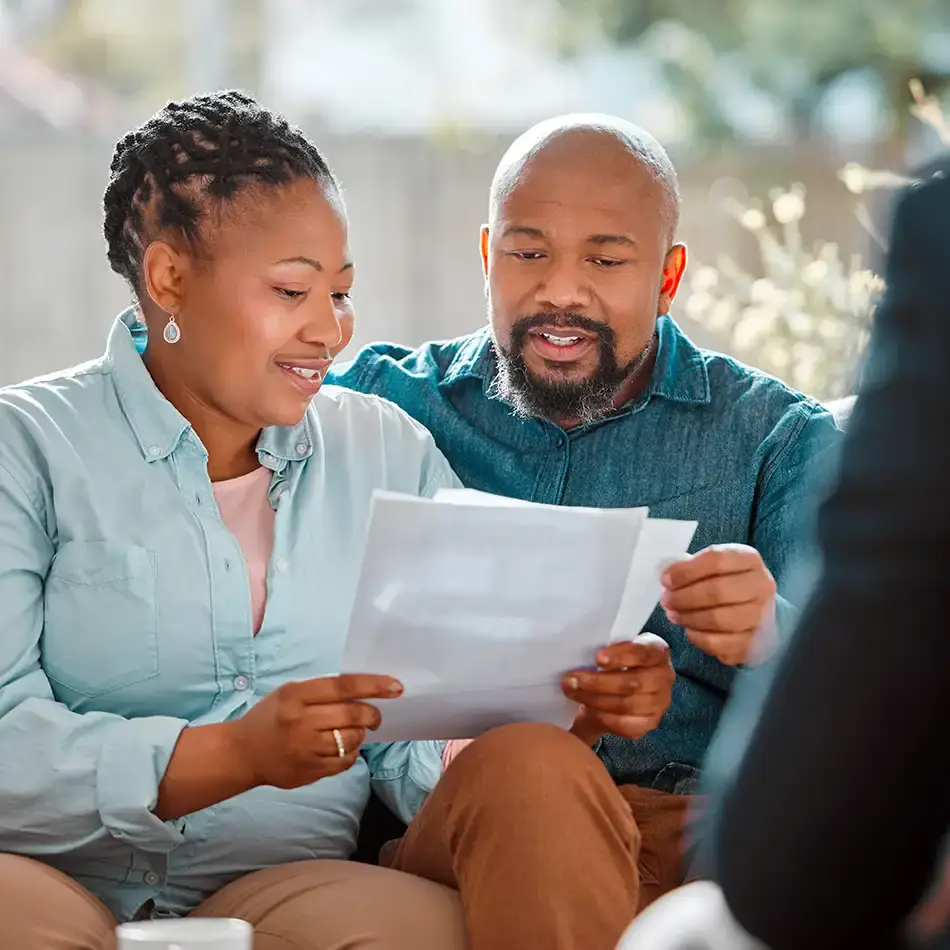Couple reviewing financial documents with a professional advisor