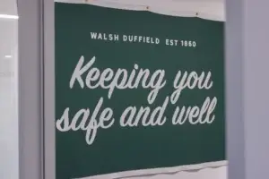 Sign that says "Keeping You Safe and Well" at the Walsh Buffalo office