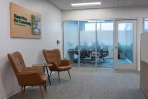 Picture of people meeting behind frosted glass in a meeting room at the Walsh Buffalo office