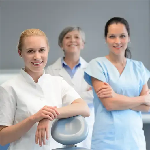Smiling team of female dental professionals and nurses in a clinic